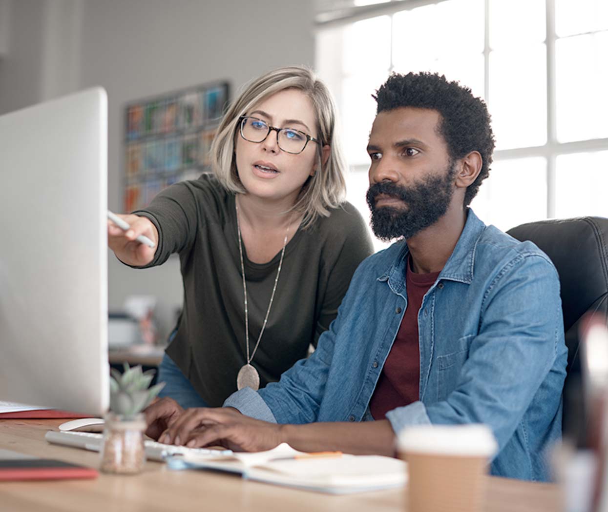 Co-workers looking at a computer screen.