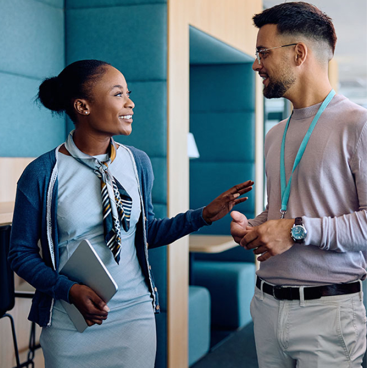 Two co-workers speaking to each other.