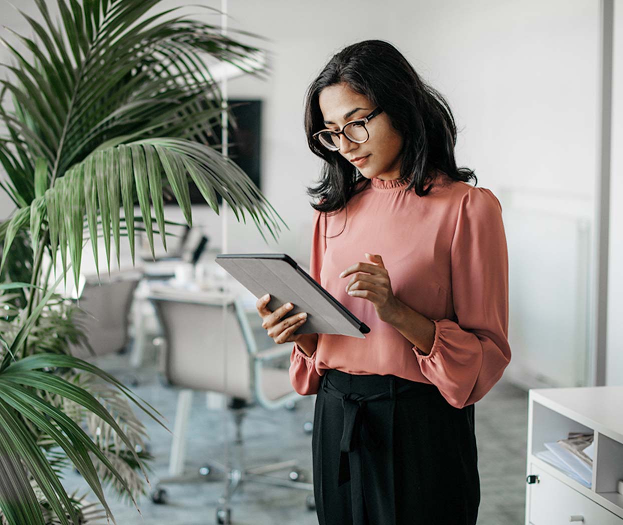 A female executive looking at a tablet.