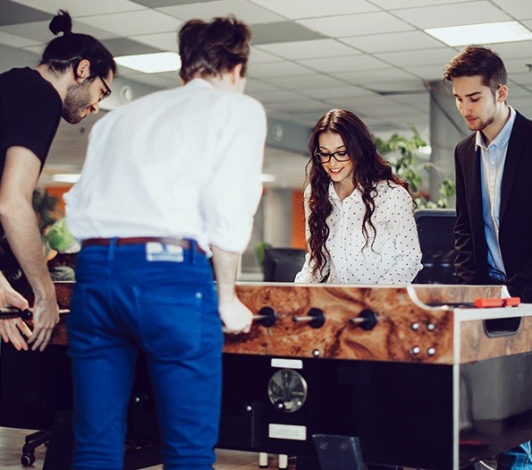 Employees playing foosball at the office